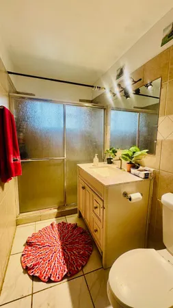 a bathroom with a sink mirror vanity and toilet