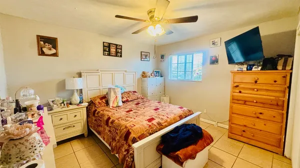 a bedroom with a bed and flat screen tv