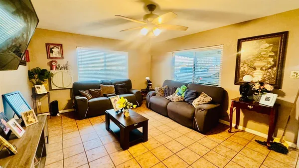 a living room with fireplace furniture and a flat screen tv
