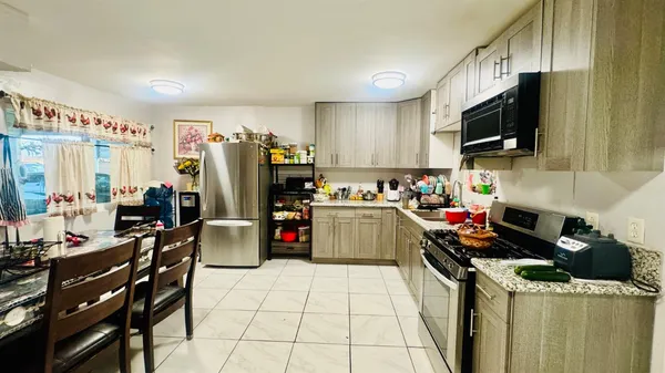 a kitchen with a sink appliances and cabinets