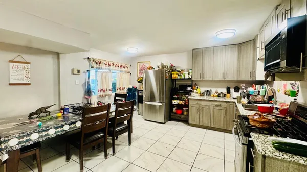 a kitchen with refrigerator and cabinets