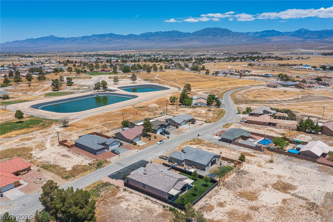 441 Belville Road Pahrump, NV 89048 - Photo 42 of 44 An aerial perspective reveals a quiet neighborhood nestled against a majestic mountain range.