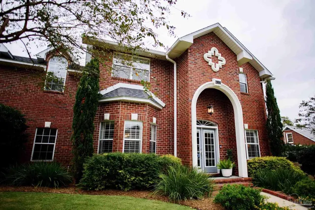 a front view of a house with garden