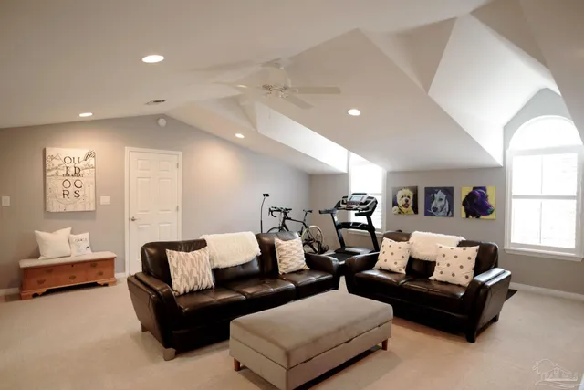 a front view of a house with garden and sitting area