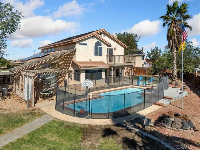 a view of a white house with a sink and a table and chairs