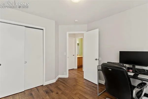 a view of a workspace with furniture and wooden floor