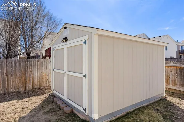 a view of a backyard with wooden fence