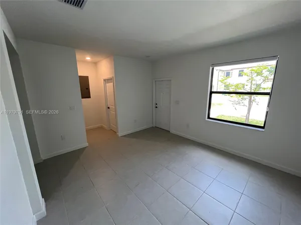 a view of an empty room with a window
