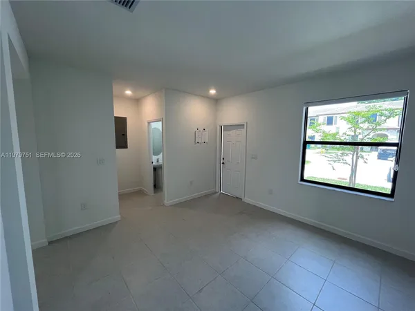a view of hallway with window and stairs