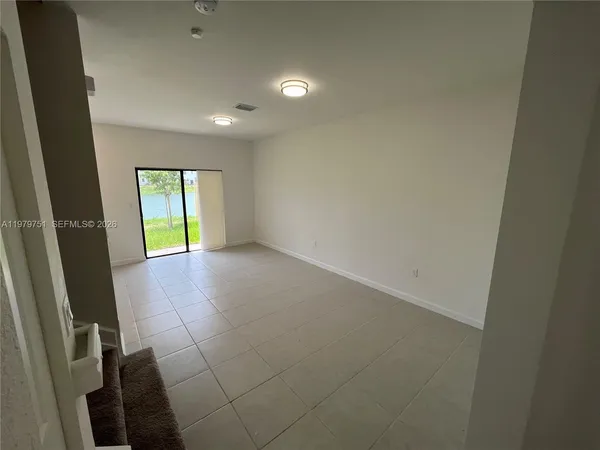 a view of an empty room with a window