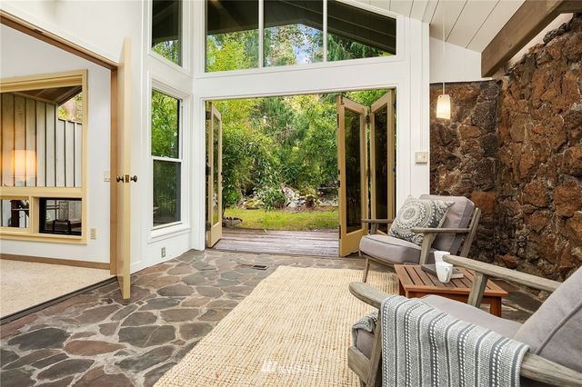 a living room with a large window and yard