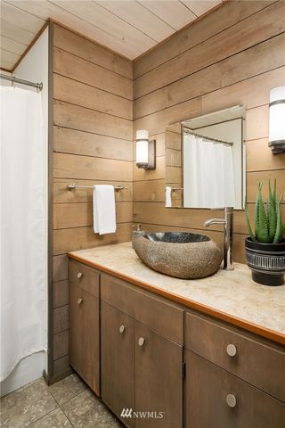 a kitchen with a sink and wooden floor