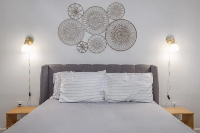 a bedroom with a bed and a chandelier