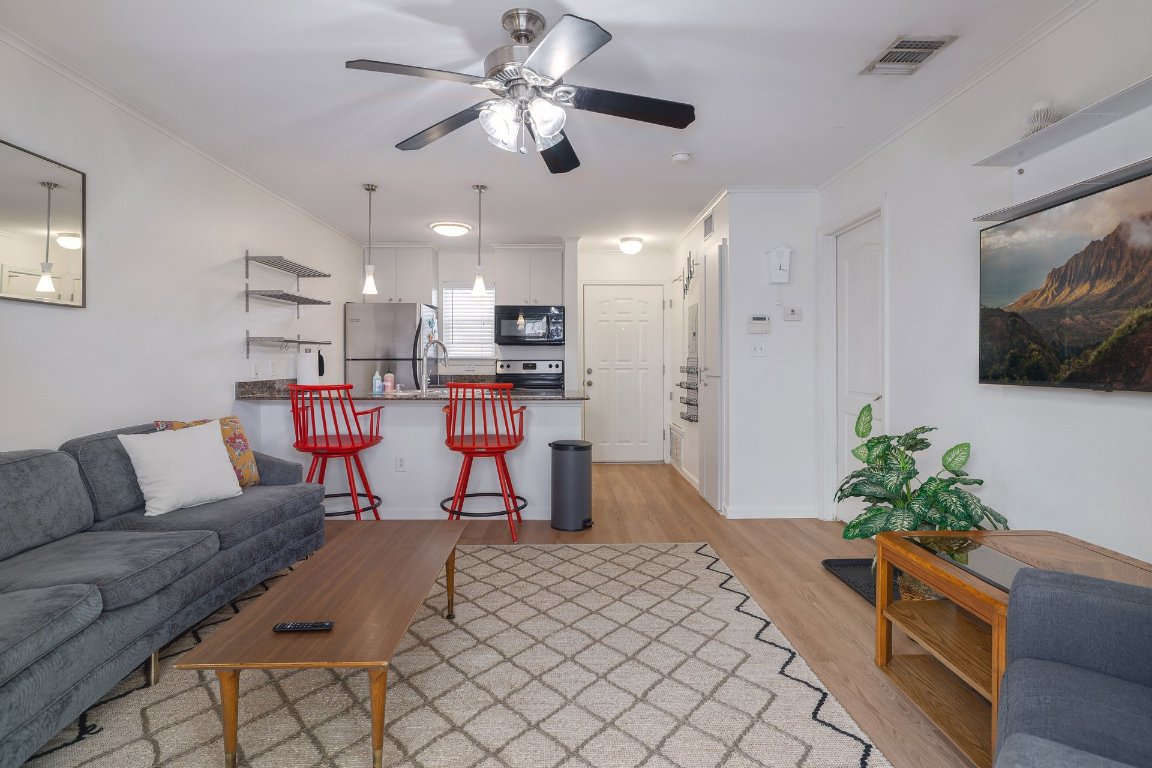 1422 Collier Street, Unit 105 Austin, TX 78704 - Photo 3 of 27 a living room with furniture and kitchen view