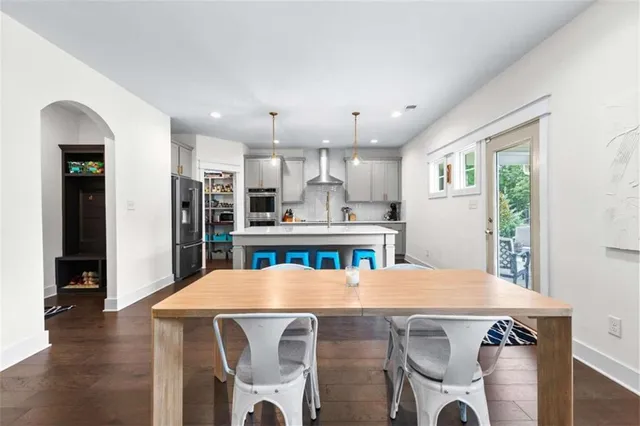 a view of a dining room with furniture and wooden floor