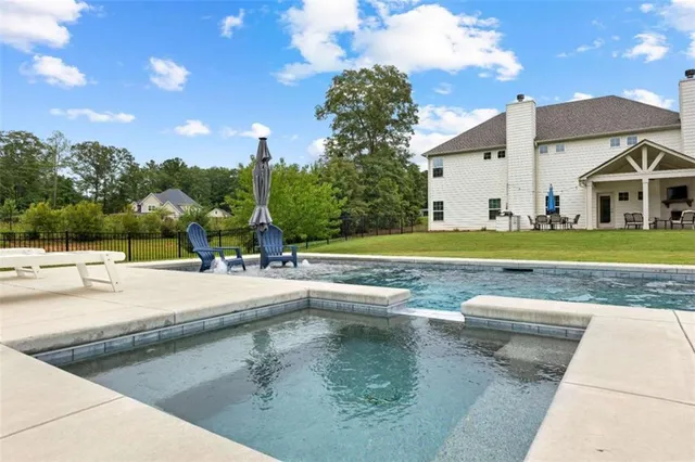 a view of a patio with a table and chairs under an umbrella