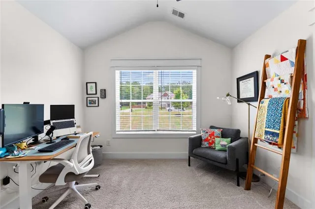 a livingroom with workspace and a window