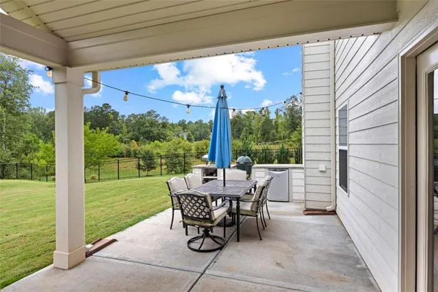 a view of a patio with a table chairs and backyard