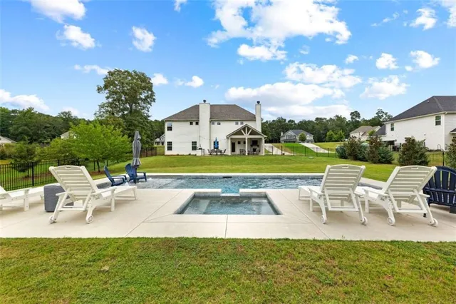 a view of a chairs and table in the back yard