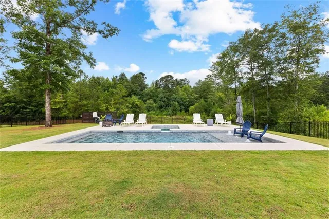 a view of a swimming pool with a chair and tables