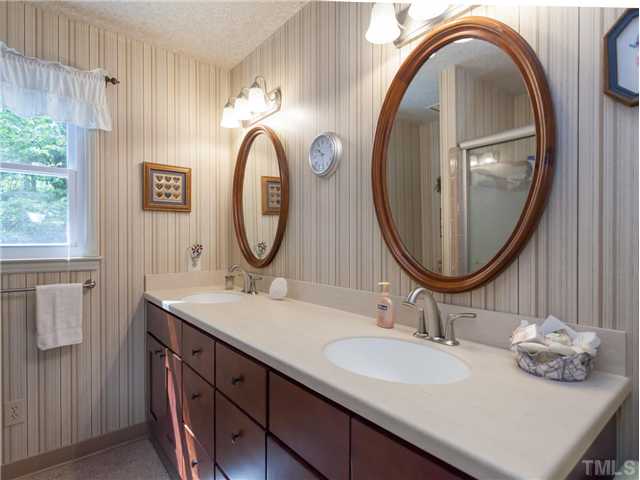 12601 Kristy Circle Raleigh, NC 27613 - Photo 17 of 25 a bathroom with a sink and a mirror