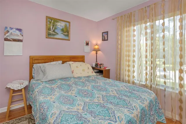 a bedroom with a bed and a painting on the wall