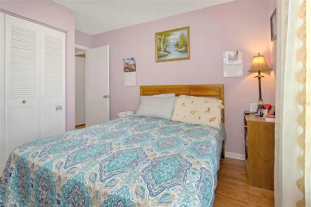 a bedroom with a bed and a painting on the wall