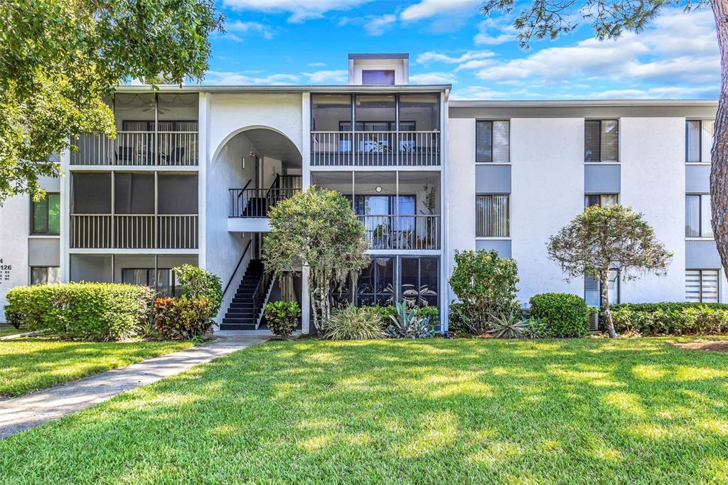 1344 Pine Ridge Circle East, Unit D2 Tarpon Springs, FL 34688 - Photo 2 of 44 a front view of a house with garden