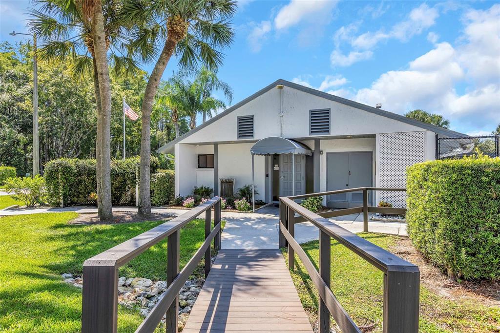 1344 Pine Ridge Circle East, Unit D2 Tarpon Springs, FL 34688 - Photo 21 of 44 a front view of house with yard and outdoor seating