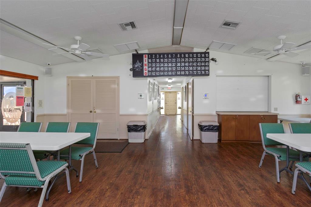 1344 Pine Ridge Circle East, Unit D2 Tarpon Springs, FL 34688 - Photo 26 of 44 a open kitchen with stainless steel appliances granite countertop a dining table chairs and a refrigerator