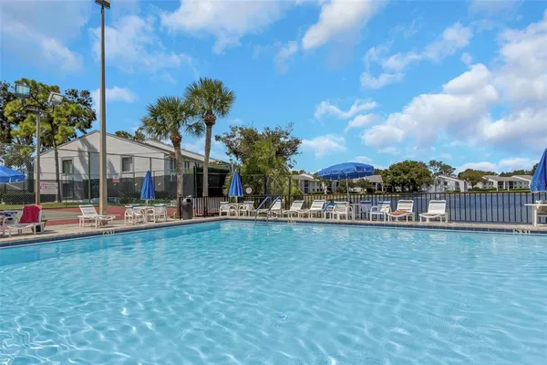 a view of a house with a swimming pool and a yard