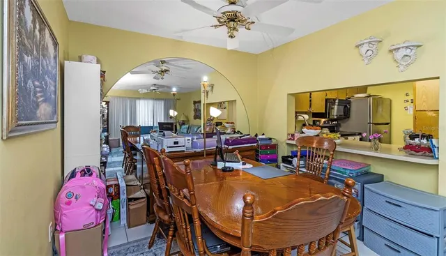 a view of a dining room with furniture and a chandelier
