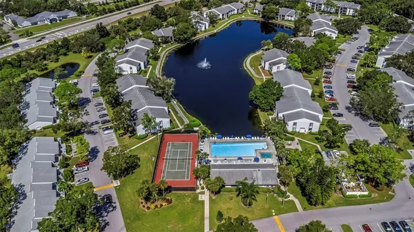 an aerial view of a house with a garden and swimming pool
