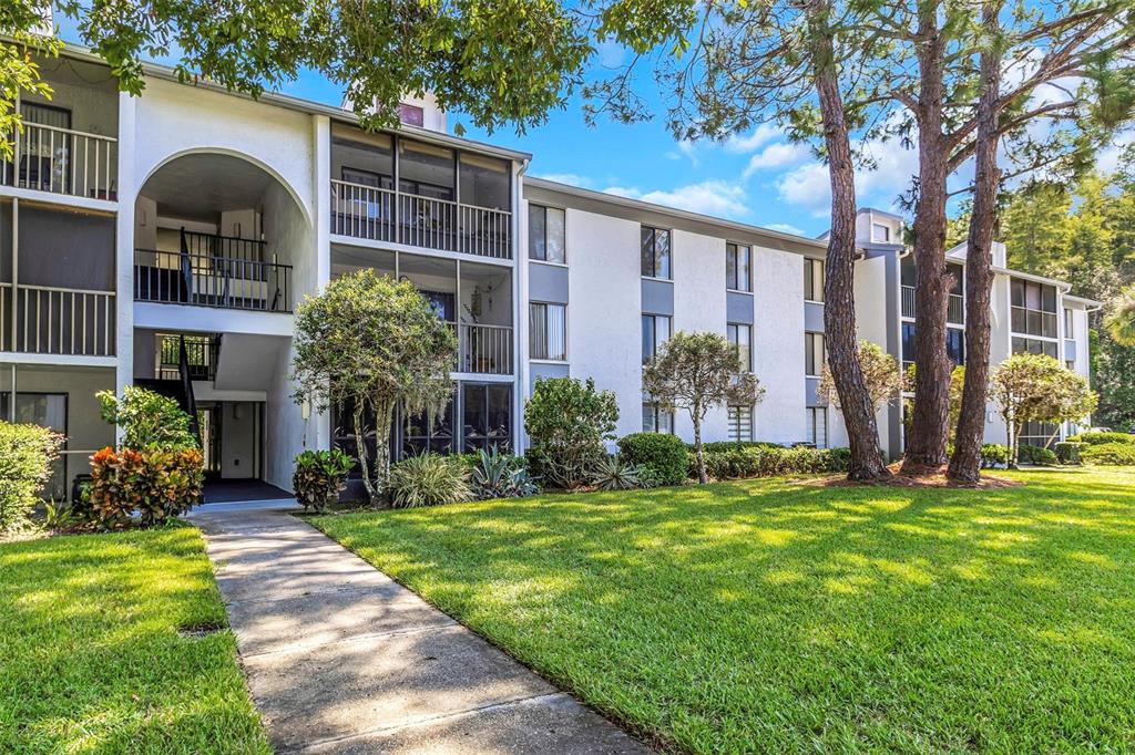1344 Pine Ridge Circle East, Unit D2 Tarpon Springs, FL 34688 - Photo 6 of 44 a front view of a house with garden