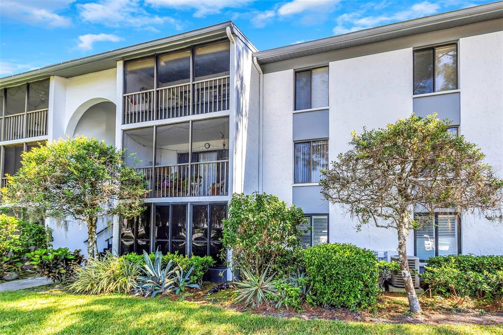 1344 Pine Ridge Circle East, Unit D2 Tarpon Springs, FL 34688 - Photo 7 of 44 a front view of a house with garden