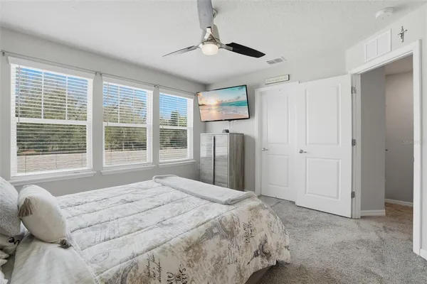 a bedroom with a bed closet and a window