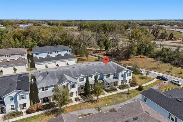 an aerial view of residential houses with outdoor space