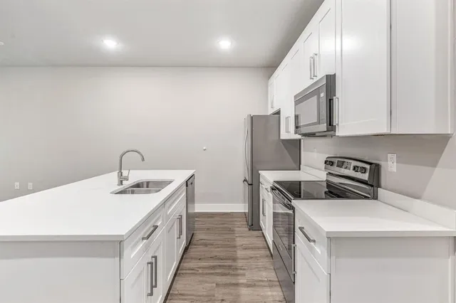a kitchen with a sink stove and refrigerator