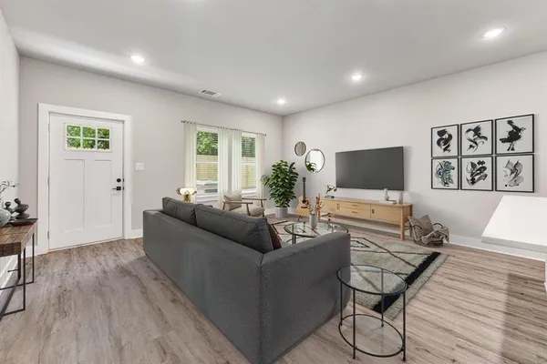 a living room with furniture and a flat screen tv