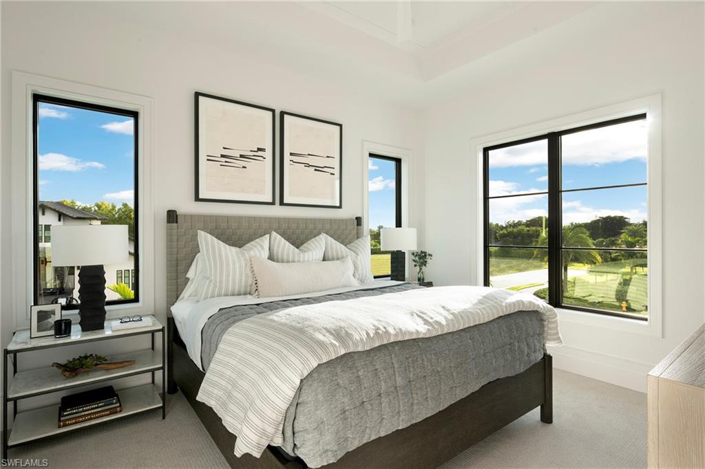 6704 Newport Road Naples, FL 34109 - Photo 21 of 47 a bedroom with a bed and two large window