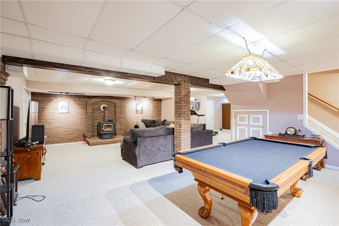 6743 Cedar Ridge Trail Clinton, OH 44216 - Photo 33 of 42 Playroom featuring a wood stove, a drop ceiling, brick wall, and pool table