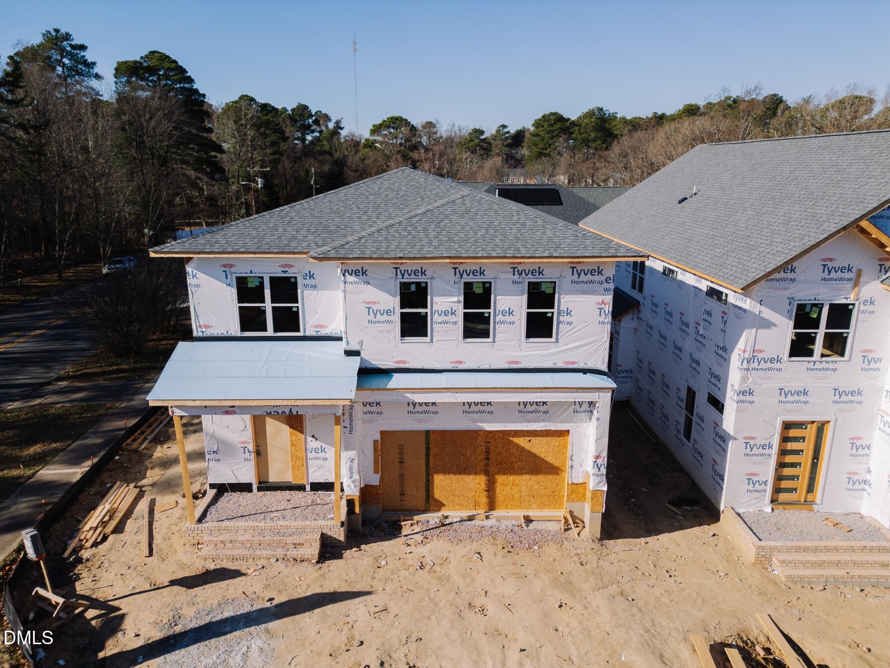 1005 Addison Place Raleigh, NC 27610 - Photo 14 of 47 a view of a white house with large windows and a yard