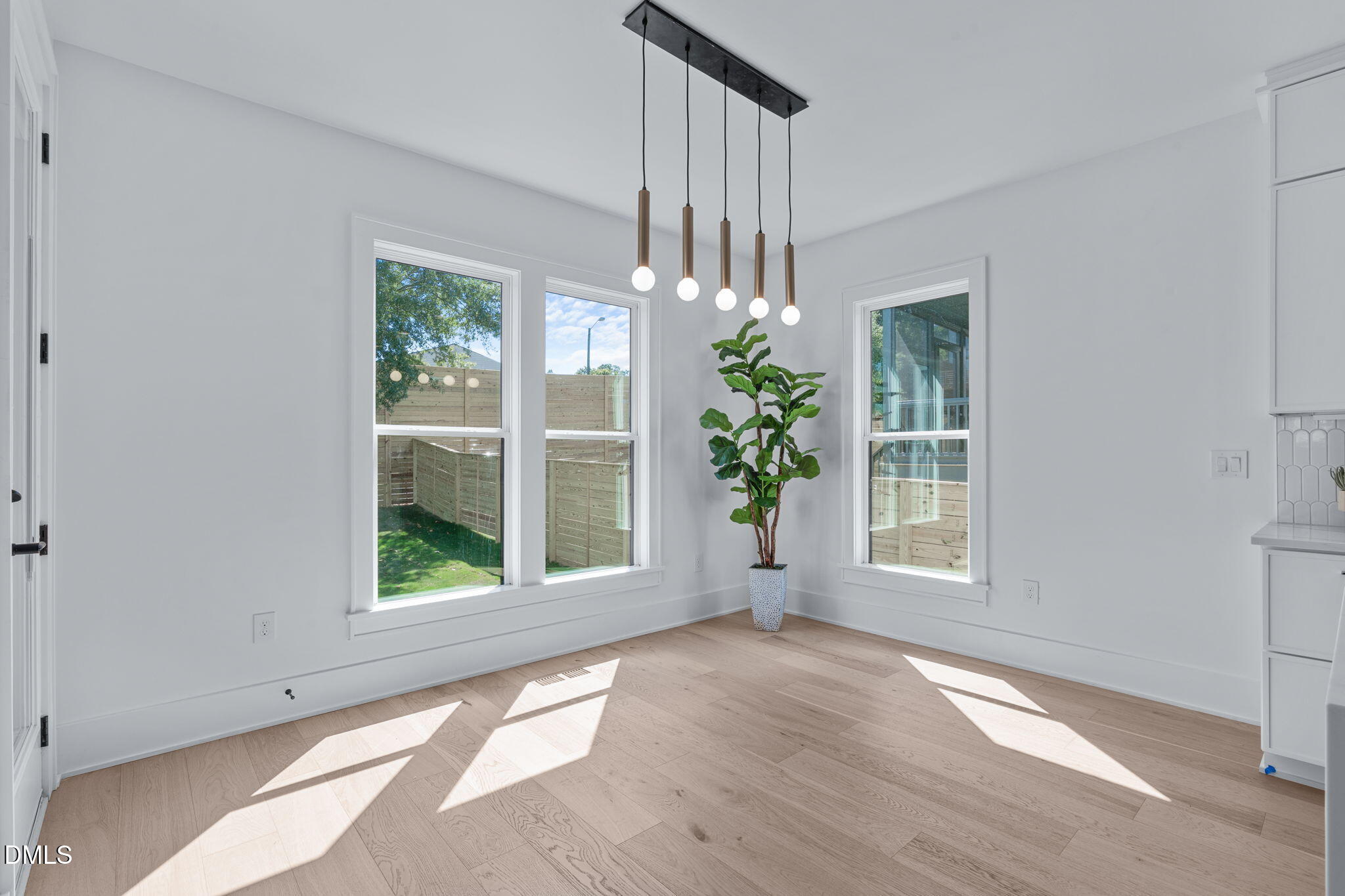 1005 Addison Place Raleigh, NC 27610 - Photo 16 of 42 an empty room with wooden floor and a window