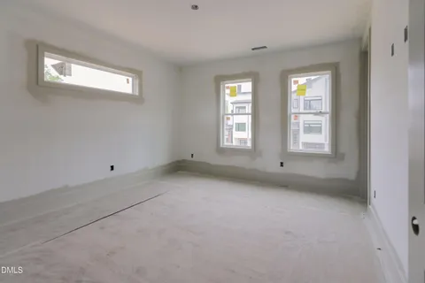 a living room with furniture a fireplace and a floor to ceiling window