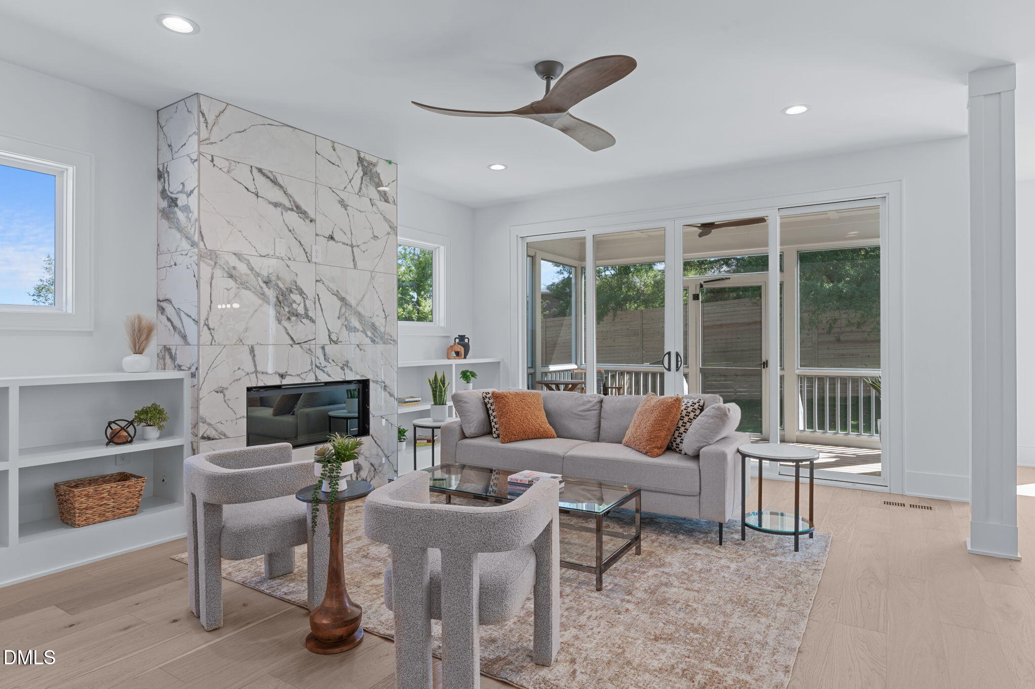 1005 Addison Place Raleigh, NC 27610 - Photo 10 of 42 a living room with furniture a fireplace and a floor to ceiling window
