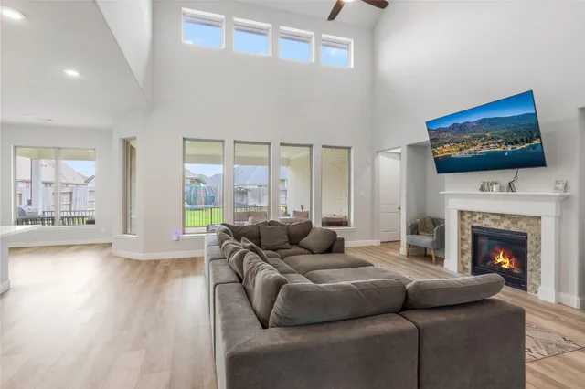 a living room with furniture a fireplace and a flat screen tv