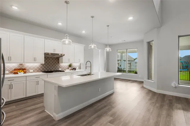 a kitchen with granite countertop white cabinets and white appliances