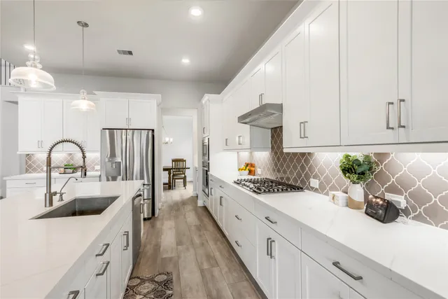 a spacious bathroom with a shower sink and mirror