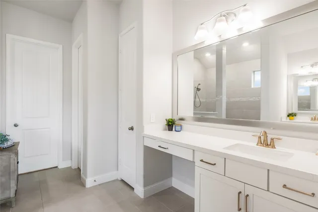 a bedroom with a bed and dresser with mirror