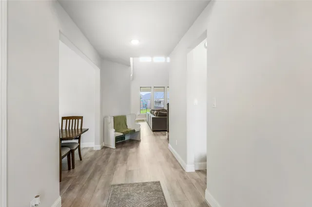 a view of a living room with furniture and wooden floor